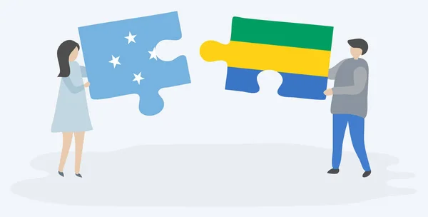 ミクロネシアとガボンの旗を持つ2つのパズルピースを保持しているカップル ミクロネシアとガボンの国のシンボル — ストックベクタ
