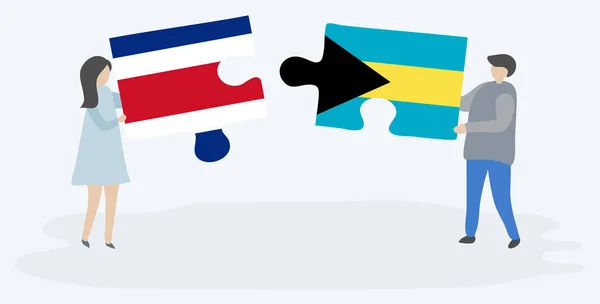 Pareja Sosteniendo Dos Piezas Rompecabezas Con Banderas Costa Rica Bahamas — Vector de stock