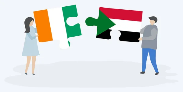Par Som Innehar Två Pusselbitar Med Ivorianska Och Sudanesiska Flaggor — Stock vektor