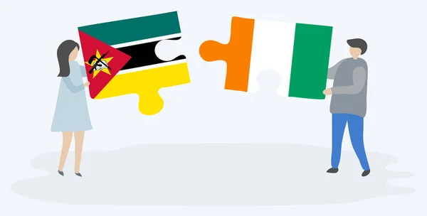 Dvojice Drží Dvě Skládanky Mosambickými Ivorianskými Vlajkami Národní Symboly Mosambiku — Stockový vektor