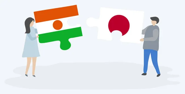 Para Trzyma Dwa Kawałki Puzzli Nigerien Japońskich Flag Symbole Narodowe — Wektor stockowy