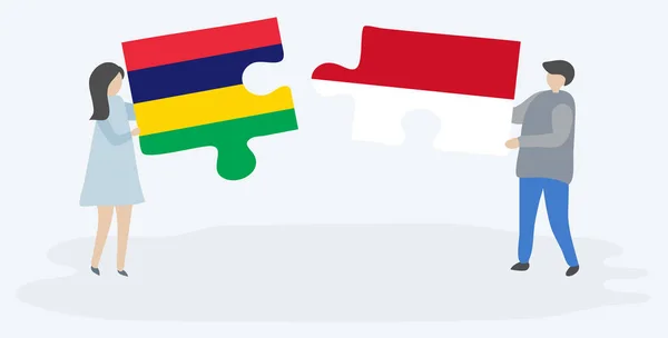 一对夫妇拿着两块拼图 上面挂着毛里求斯和印尼国旗 毛里求斯和印度尼西亚国家符号在一起 — 图库矢量图片