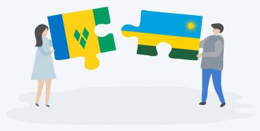 Vincentian ve Ruanda bayrakları ile iki bulmaca parçaları tutan çift. Saint Vincent ve Grenadinler ve Ruanda ulusal sembolleri birlikte.