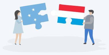 Mikronezya ve Lüksemburg bayrakları ile iki bulmaca parçaları tutan çift. Mikronezya ve Lüksemburg ulusal sembolleri birlikte.