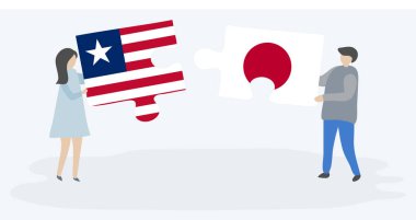 Liberya ve Japon bayrakları ile iki bulmaca parçaları tutan çift. Liberya ve Japonya ulusal sembolleri birlikte.