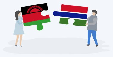 Malavi ve Gambiya bayraklarıyla iki bulmaca tutan çift. Malavi ve Gambiya ulusal sembolleri birlikte.