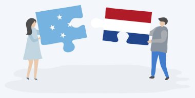 Mikronezya ve Hollanda bayrakları ile iki bulmaca parçaları tutan çift. Mikronezya ve Hollanda ulusal sembolleri birlikte.