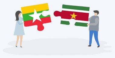Çift Birmanya ve Surinam bayrakları ile iki bulmaca parçaları tutan. Myanmar ve Surinam ulusal sembolleri birlikte.