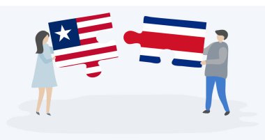 Liberya ve Kosta Rika bayrakları ile iki bulmaca parçaları tutan çift. Liberya ve Kosta Rika ulusal sembolleri birlikte.