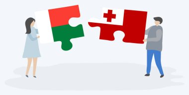 Çift Malagasy ve Tongan bayrakları ile iki bulmaca parçaları tutan. Madagaskar ve Tonga ulusal sembolleri birlikte.