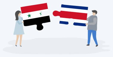 Suriye ve Kosta Rika bayrakları ile iki bulmaca parçaları tutan çift. Suriye ve Kosta Rika ulusal sembolleri birlikte.
