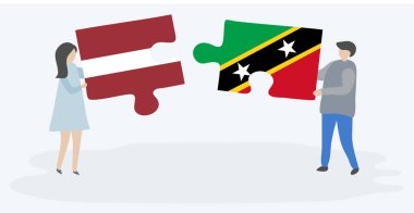 Leton ve Kittitian bayrakları ile iki bulmaca parçaları tutan çift. Letonya ve Saint Kitts ve Nevis ulusal sembolleri birlikte.