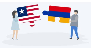 Liberya ve Ermeni bayraklarıyla iki bulmaca tutan çift. Liberya ve Ermenistan ulusal sembolleri birlikte.