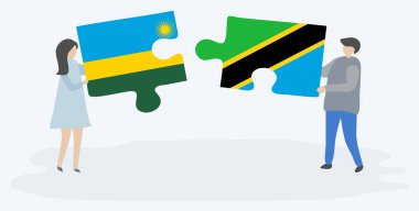 Ruanda ve Tanzanya bayrakları ile iki bulmaca parçaları tutan çift. Ruanda ve Tanzanya ulusal sembolleri birlikte.