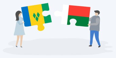 Vincentian ve Malagasy bayrakları ile iki bulmaca parçaları tutan çift. Saint Vincent ve Grenadinler ve Madagaskar ulusal sembolleri birlikte.