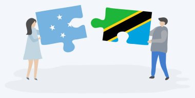 Mikronezya ve Tanzanya bayrakları ile iki bulmaca parçaları tutan çift. Mikronezya ve Tanzanya ulusal sembolleri birlikte.