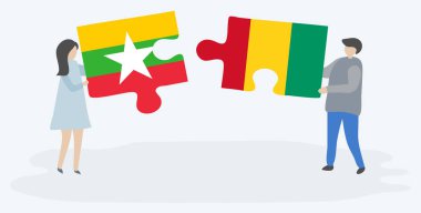 Birmanya ve Gine bayrakları ile iki bulmaca parçaları tutan çift. Myanmar ve Gine ulusal sembolleri birlikte.