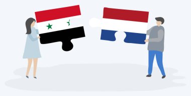 Suriye ve Hollanda bayrakları ile iki bulmaca parçaları tutan çift. Suriye ve Hollanda ulusal sembolleri birlikte.