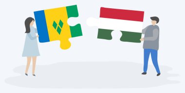 Vincentian ve Macar bayrakları ile iki bulmaca parçaları tutan çift. Saint Vincent ve Grenadinler ve Macaristan ulusal sembolleri birlikte.