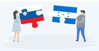 Sloven ve Honduras bayrakları ile iki bulmaca parçaları tutan çift. Slovenya ve Honduras ulusal sembolleri birlikte.