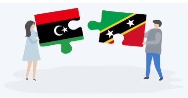 Libya ve Kittiti bayrakları ile iki bulmaca parçaları tutan çift. Libya ve Saint Kitts ve Nevis ulusal sembolleri birlikte.