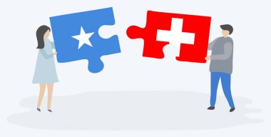 Çift, Somali ve İsviçre bayraklarıyla iki bulmaca parçası tutuyor. Somali ve İsviçre ulusal sembolleri birlikte.