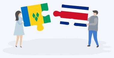 Vincentian ve Kosta Rika bayrakları ile iki bulmaca parçaları tutan çift. Saint Vincent ve Grenadinler ve Kosta Rika ulusal sembolleri birlikte.