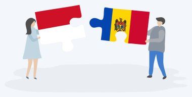 Monegasque ve Moldova bayrakları ile iki bulmaca parçaları tutan çift. Monako ve Moldova ulusal sembolleri birlikte.