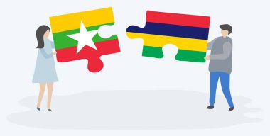 Birmanya ve Moritanya bayrakları ile iki bulmaca parçaları tutan çift. Myanmar ve Mauritius ulusal sembolleri birlikte.
