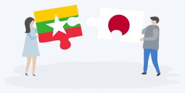 Çift Birmanya ve Japon bayrakları ile iki bulmaca parçaları tutan. Myanmar ve Japonya ulusal sembolleri birlikte.