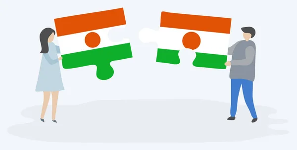 Dvojice Drží Dvě Skládanky Vlajkami Nigerien Nigerien Národní Symboly Niger — Stockový vektor
