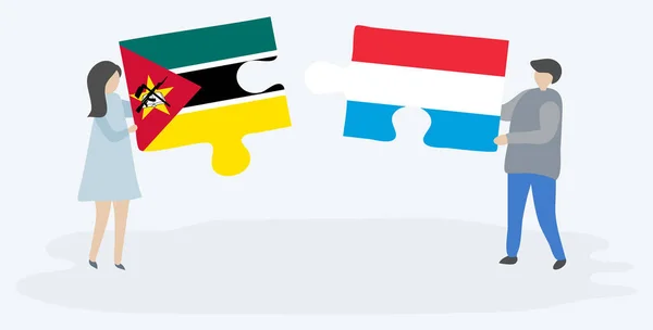 Pareja Sosteniendo Dos Piezas Rompecabezas Con Banderas Mozambiqueñas Luxemburguesas Mozambique — Vector de stock
