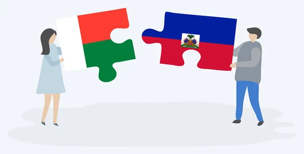 Paar Houden Twee Puzzels Stukken Met Malagasi Haïtiaanse Vlaggen Madagaskar — Stockvector
