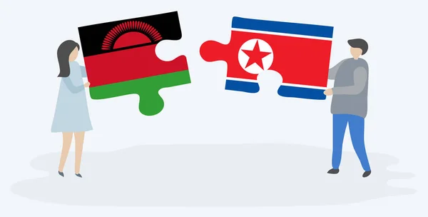 Dvojice Drží Dvě Skládanky Malawianskými Severokorejskými Vlajkami Vnitrostátní Symboly Malawi — Stockový vektor