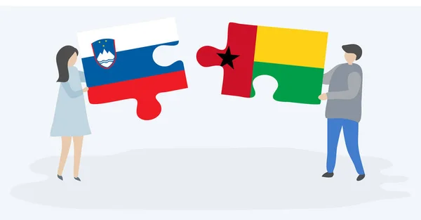 Para Trzyma Dwa Kawałki Puzzli Flag Słoweńskich Bissau Gwinejan Symbole — Wektor stockowy