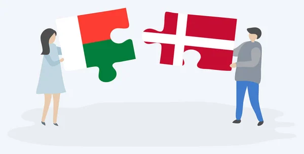 Pareja Sosteniendo Dos Piezas Rompecabezas Con Banderas Malgaches Danesas Madagascar — Archivo Imágenes Vectoriales