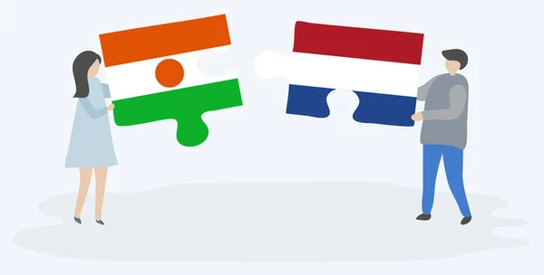 Couple Tenant Deux Pièces Puzzles Avec Des Drapeaux Nigériens Néerlandais — Image vectorielle