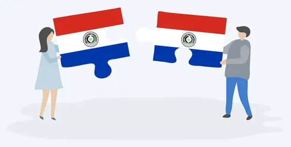 パラグアイとパラグアイの旗を持つ2つのパズルピースを保持しているカップル パラグアイとパラグアイの国のシンボル — ストックベクタ