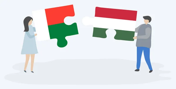 Para Trzyma Dwa Kawałki Puzzli Madagaskaru Węgierskich Flag Madagaskar Węgier — Wektor stockowy