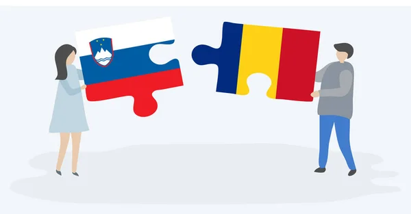 Para Trzyma Dwa Kawałki Puzzli Flag Słoweńskich Rumuńskich Symbole Narodowe — Wektor stockowy