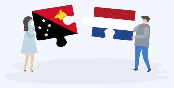 一对夫妇拿着两块带有巴布亚和荷兰国旗的拼图 巴布亚新几内亚和荷兰国家符号在一起 — 图库矢量图片