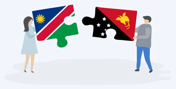 Pareja Sosteniendo Dos Piezas Rompecabezas Con Banderas Namibia Papúa Namibia — Vector de stock
