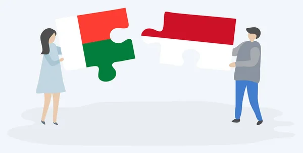 Par Som Innehar Två Pusselbitar Med Madagassiska Och Indonesiska Flaggor — Stock vektor