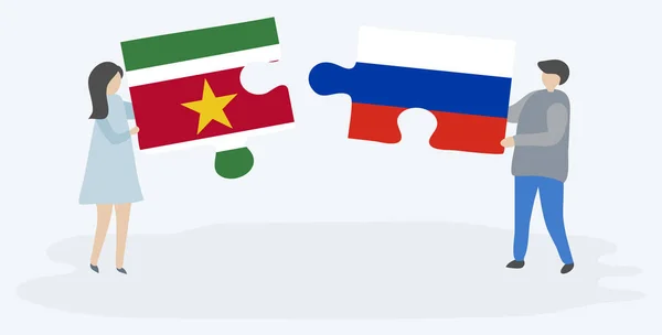 Ζευγάρι Που Κρατά Δύο Κομμάτια Παζλ Σουρινάμ Και Ρωσικά Σημαίες — Διανυσματικό Αρχείο