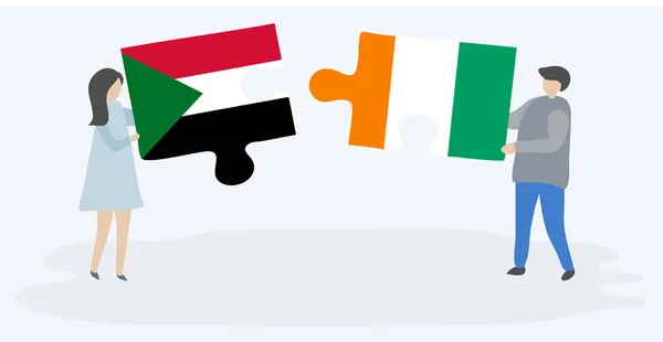 Casal Segurando Duas Peças Quebra Cabeças Com Bandeiras Sudanesas Marfinenses — Vetor de Stock