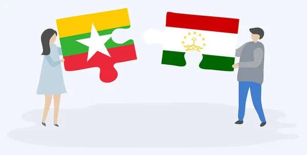 Para Trzyma Dwa Kawałki Puzzli Birmański Tadżycki Flagi Mjanma Tadżykistan — Wektor stockowy