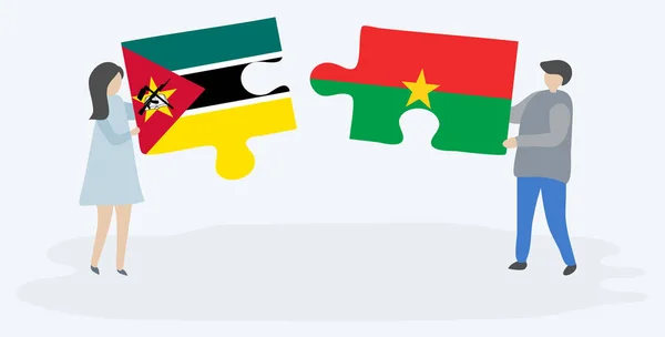 Couple Tenant Deux Pièces Puzzles Avec Des Drapeaux Mozambicains Burkinabés — Image vectorielle