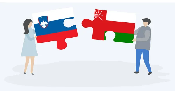 一对夫妇拿着两个拼图 上面挂着斯洛文尼亚和阿曼国旗 斯洛文尼亚和阿曼国家符号在一起 — 图库矢量图片