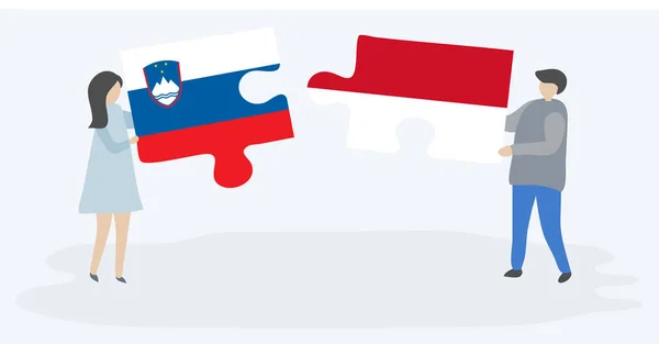 一对夫妇拿着两个拼图 上面挂着斯洛文尼亚和印度尼西亚国旗 斯洛文尼亚和印度尼西亚国家符号在一起 — 图库矢量图片