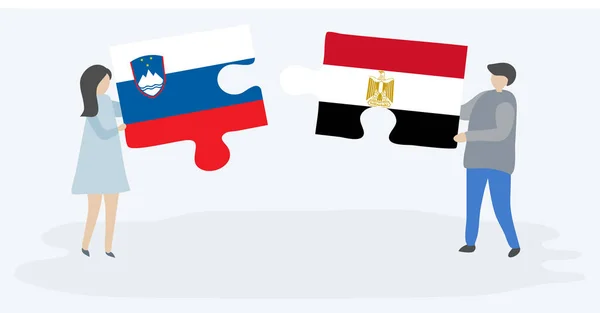 スロベニアとエジプトの旗を持つ2つのパズルのピースを保持しているカップル スロベニアとエジプトのシンボル — ストックベクタ